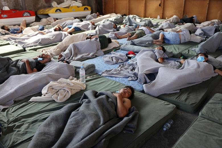 Migrants rest in a shelter, following a rescue operation, after their boat capsized at open sea, in Kalamata, Greece, June 14.