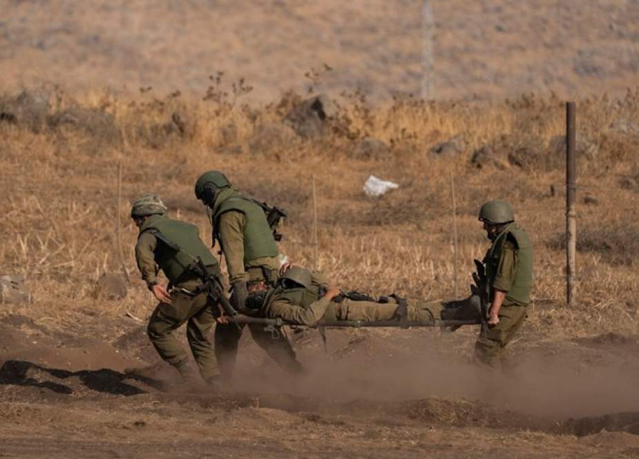 Israeli soldiers carry a soldier on a stretcher during a drill, Lebanese-Palestinian borders
