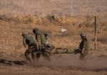 Israeli soldiers carry a soldier on a stretcher during a drill, Lebanese-Palestinian borders