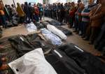 Palestinians pray over the bodies of loved ones killed during Israeli bombardment in southern Gaza Strip