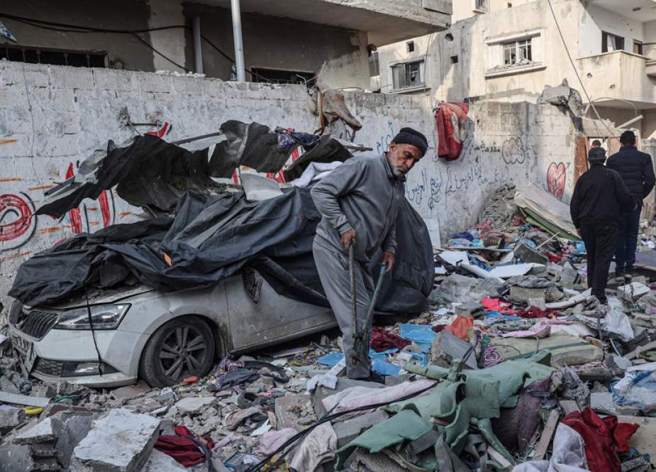 Palestinians salvage belongings from the rubble of buildings destroyed in Israeli airstrike in the Rafah refugee camp in the southern Gaza Strip