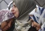 Palestinian women mourn realtives killed during an Israeli bombardment of Najjar Hospital in Rafah